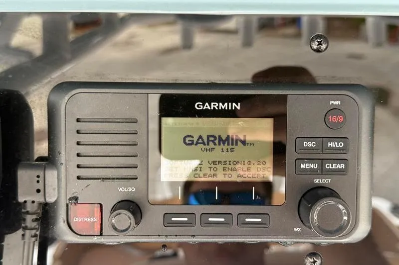 Slide: The Image of Garmin VHF 115 radio on 2023 Sea Hunt Ultra 255 SE boat dashboard. - 25
