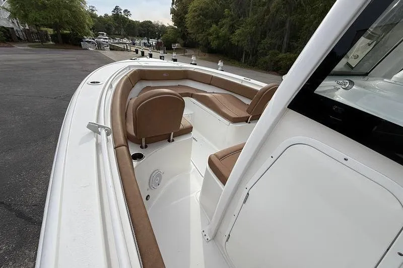 Slide: The Image of 2023 Sea Hunt Ultra 255 SE boat interior with brown seating and white deck. - 28