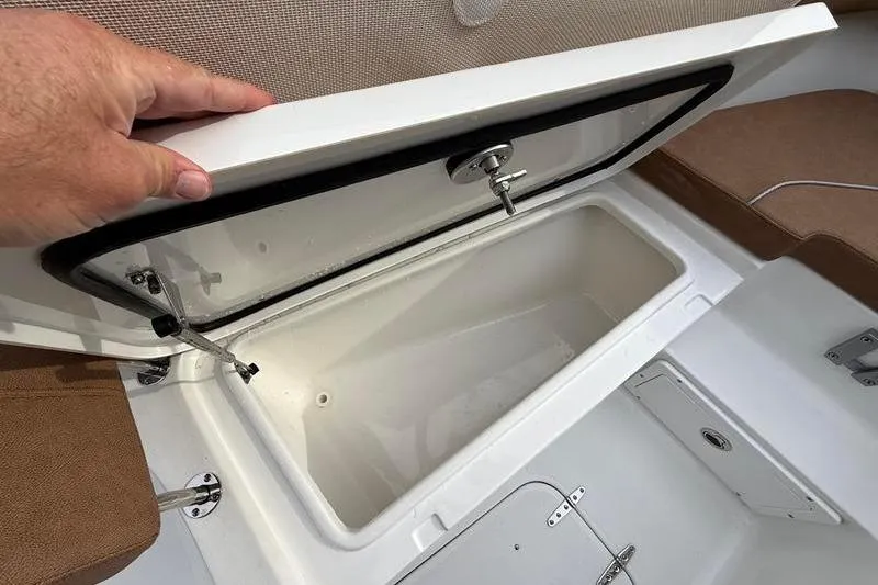 Slide: The Image of Open storage compartment on 2023 Sea Hunt Ultra 255 SE boat, showcasing interior space. - 34