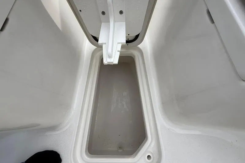 Slide: The Image of 2023 Sea Hunt Ultra 255 SE storage compartment, open and empty, showcasing interior space. - 35
