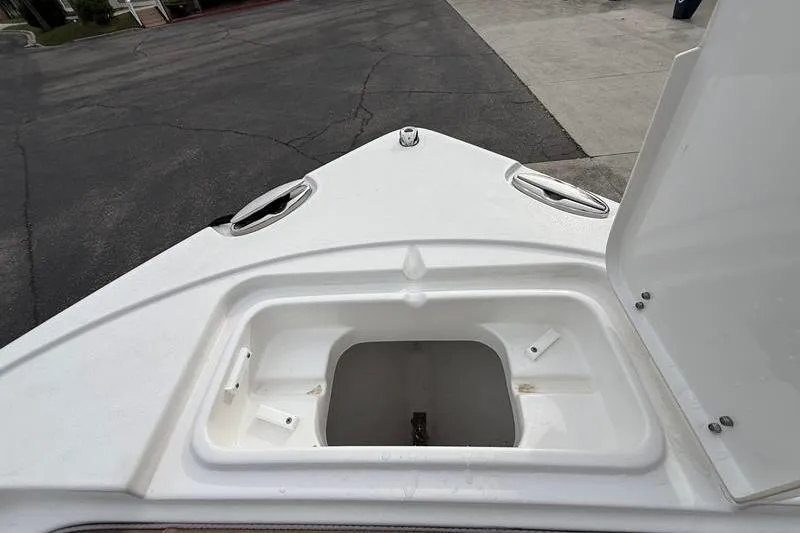 Slide: The Image of 2023 Sea Hunt Ultra 255 SE boat anchor storage compartment open on deck. - 36