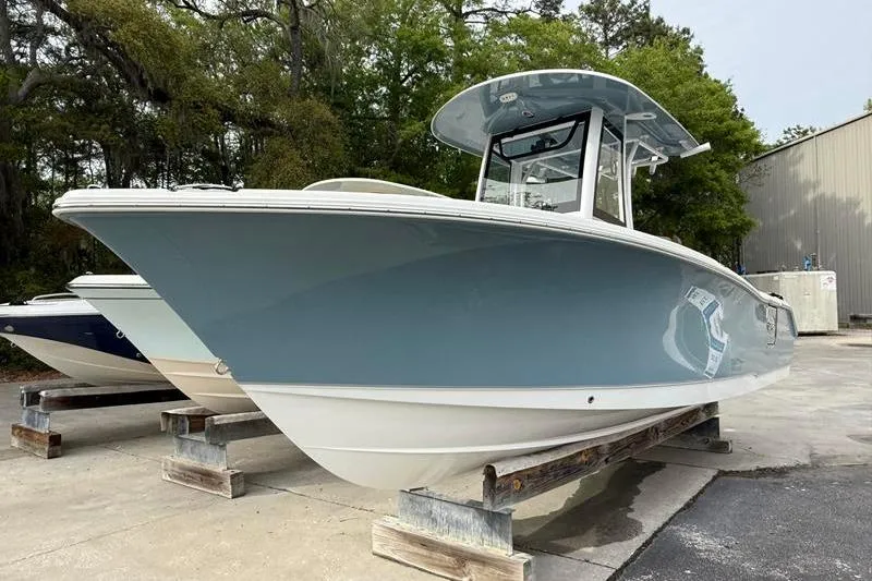 Slide: The Image of 2023 Sea Hunt Ultra 255 SE boat on display in outdoor setting. - 6