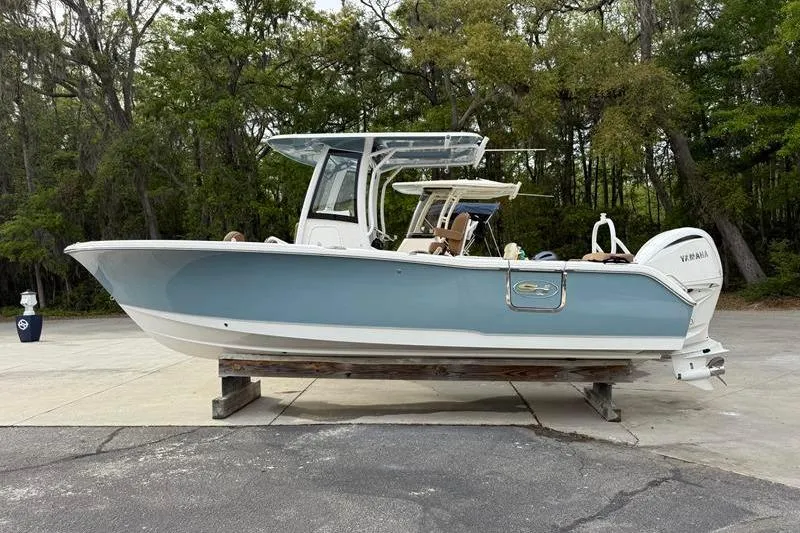 Slide: The Image of 2023 Sea Hunt Ultra 255 SE boat on display, side view, outdoors. - 7