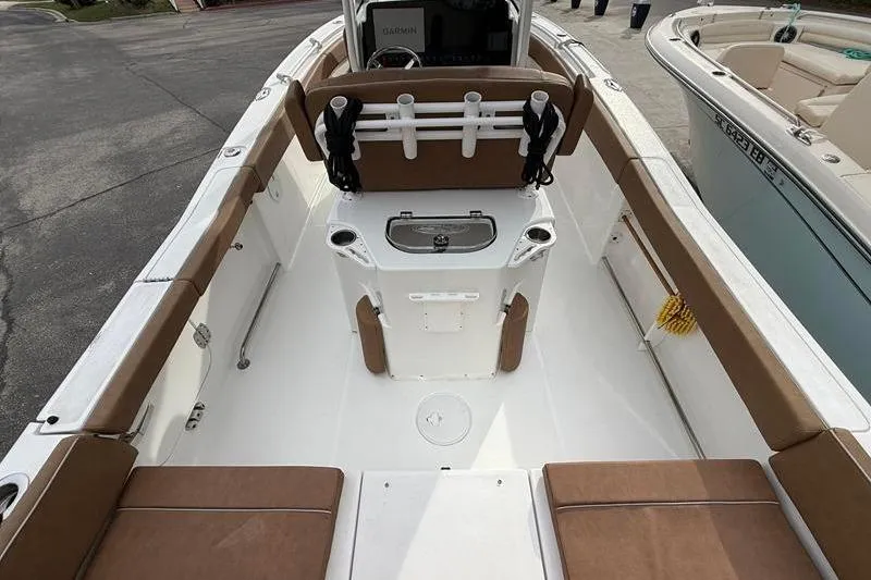 Slide: The Image of 2023 Sea Hunt Ultra 255 SE boat interior with brown seating and fishing rod holders. - 8