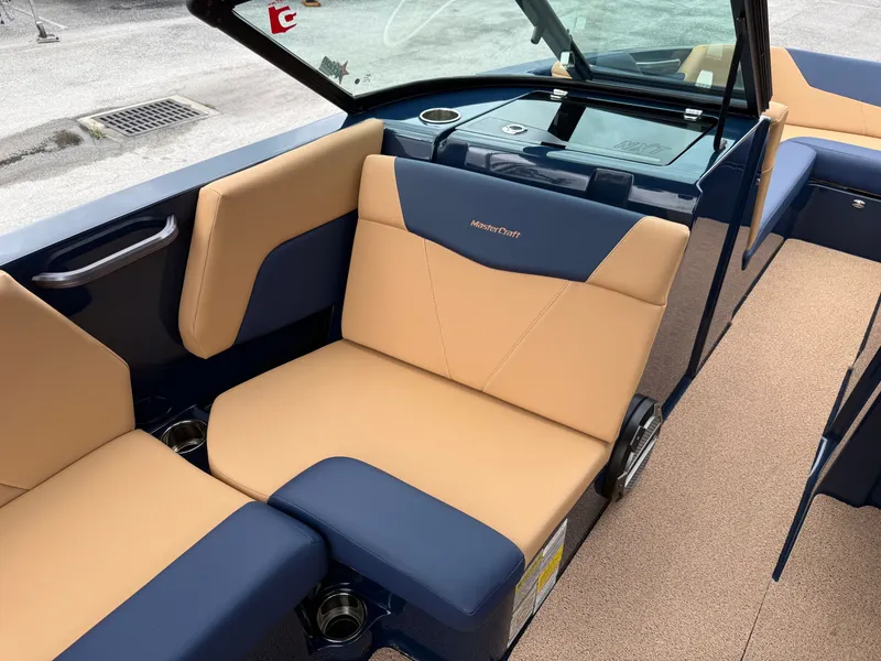 Slide: The Image of Interior of a 2022 MasterCraft NXT24 with beige and blue seating. - 12