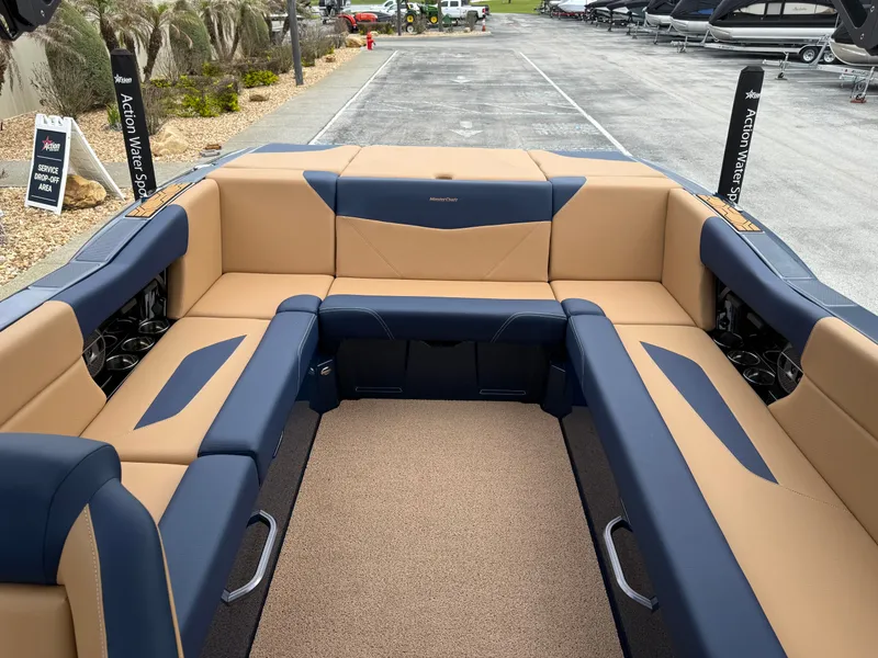 Slide: The Image of Interior of a 2022 MasterCraft NXT24 boat with blue and beige seating. - 13