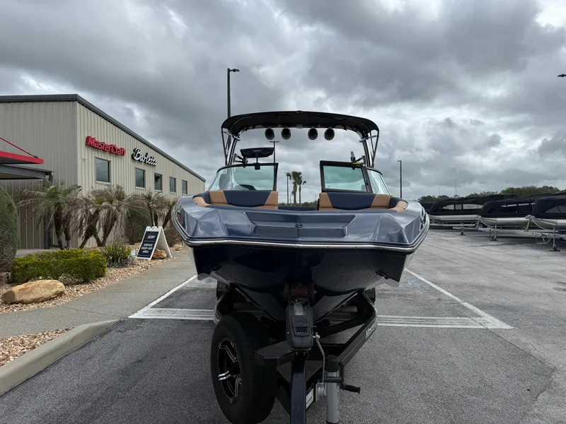 Slide: The Image of 2022 MasterCraft NXT24 boat in front of a showroom. - 3
