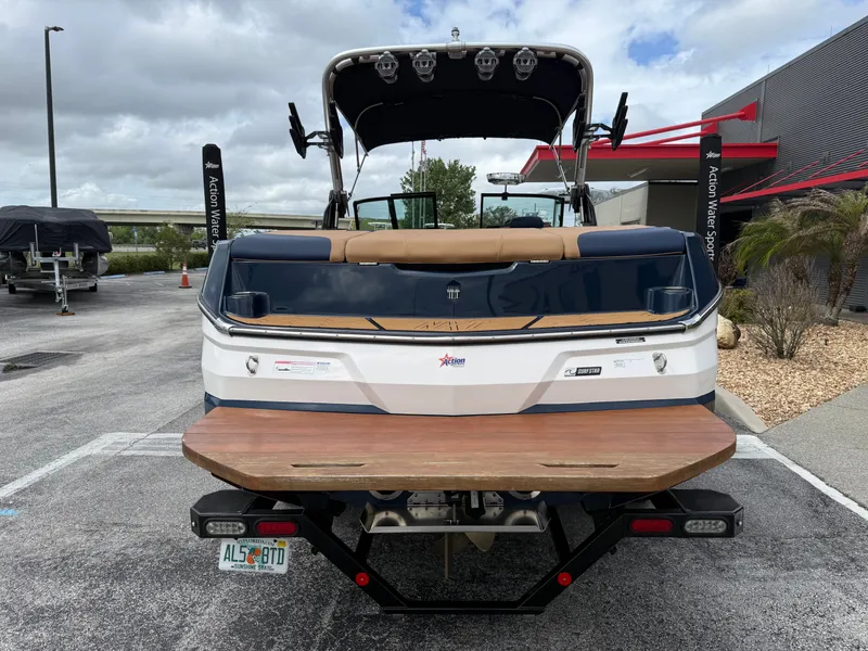Slide: The Image of Rear view of a 2022 MasterCraft NXT24 boat in a parking lot. - 7