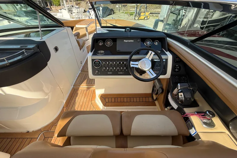 Slide: The Image of 2014 Sea Ray SLX 350 boat interior with modern helm and luxurious seating. - 12