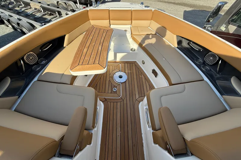 Slide: The Image of Luxurious 2014 Sea Ray SLX 350 boat interior with tan seating and wooden flooring. - 18