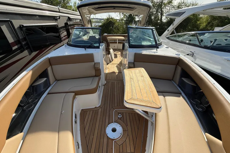 Slide: The Image of Luxurious 2014 Sea Ray SLX 350 boat interior with tan seating and wooden deck. - 19