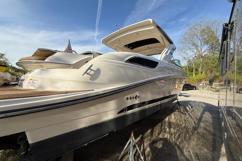 Slide: The Image of 2014 Sea Ray SLX 350 boat on dry dock under clear blue sky. - 28