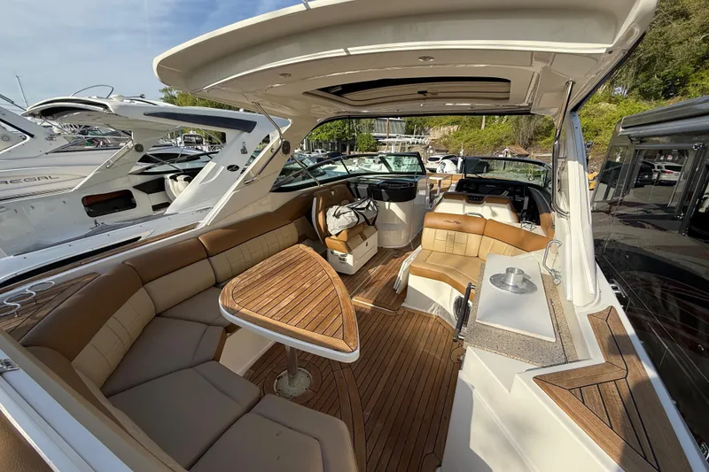 Slide: The Image of 2014 Sea Ray SLX 350 boat interior with luxurious seating and wooden accents. - 29