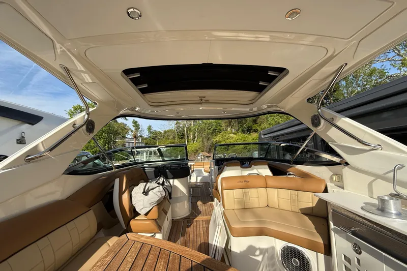 Slide: The Image of Luxurious interior of a 2014 Sea Ray SLX 350 boat with tan leather seating. - 32
