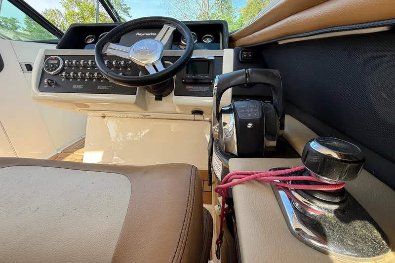 Slide: The Image of 2014 Sea Ray SLX 350 boat cockpit with steering wheel and control panel. - 36