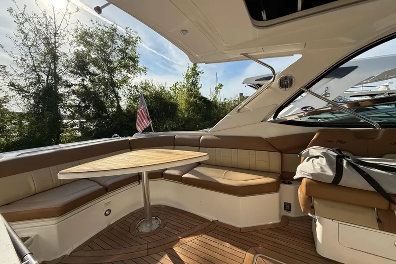 Slide: The Image of Luxurious 2014 Sea Ray SLX 350 boat interior with seating and wooden table. - 38