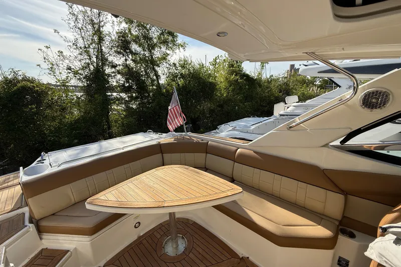 Slide: The Image of Luxurious 2014 Sea Ray SLX 350 boat interior with seating and wooden table. - 41