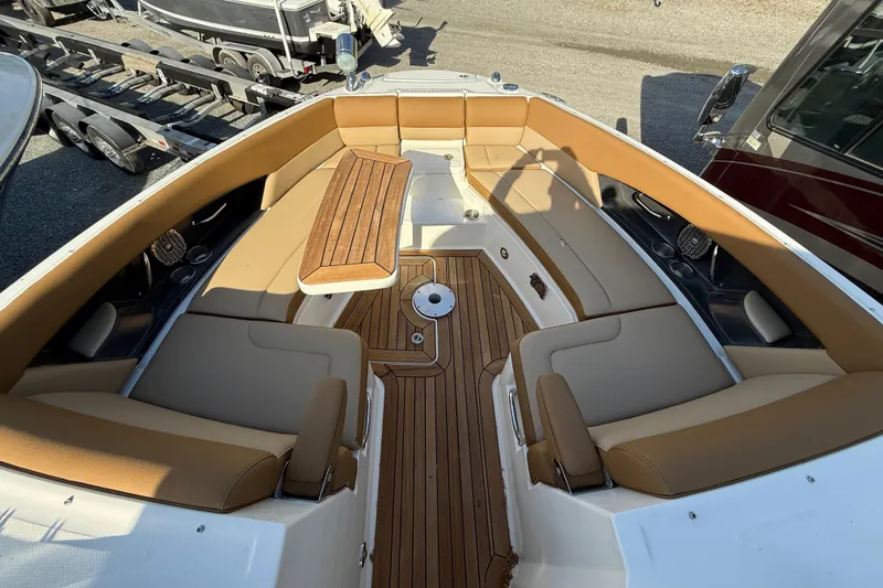 Slide: The Image of 2014 Sea Ray SLX 350 boat interior with tan seating and wooden flooring. - 42
