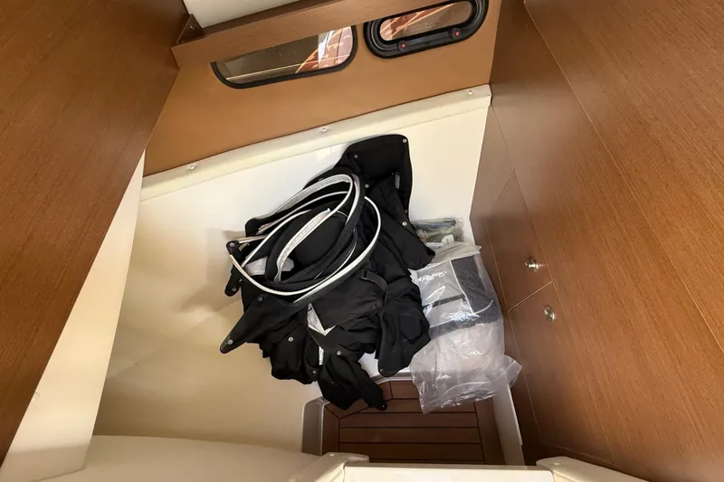 Slide: The Image of Interior cabin of 2014 Sea Ray SLX 350 with storage and wooden paneling. - 46