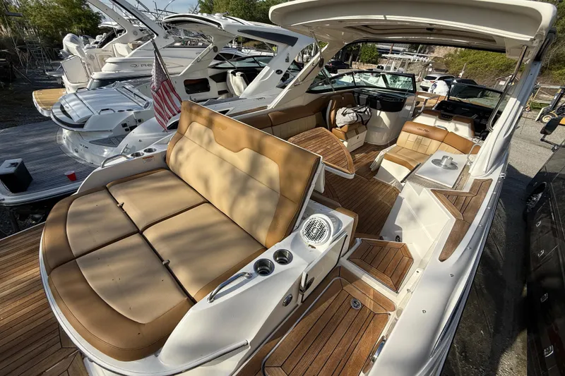 Slide: The Image of 2014 Sea Ray SLX 350 boat interior with luxurious seating and wooden accents. - 5