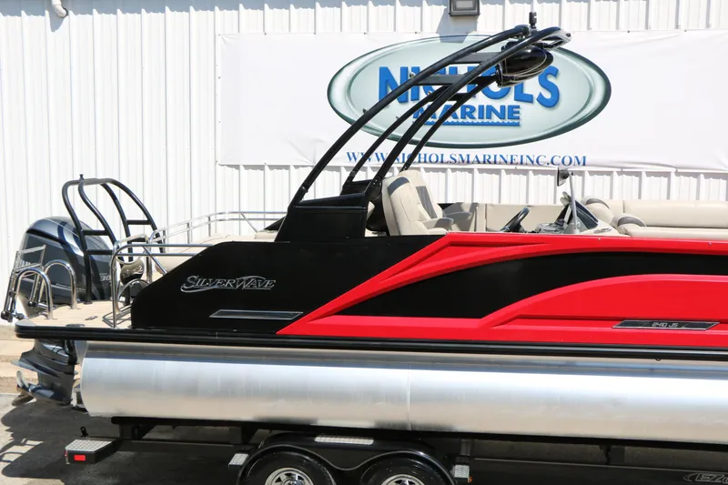 Slide: The Image of 2021 Silver Wave 2410 SW5 JS pontoon boat with sleek black and red design. - 15