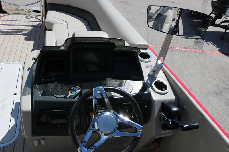 Slide: The Image of 2021 Silver Wave 2410 SW5 JS boat dashboard with steering wheel and controls. - 41