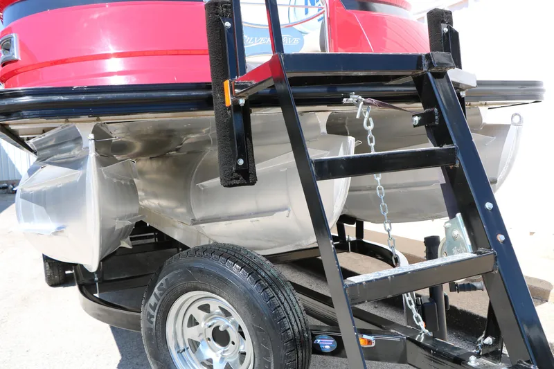 Slide: The Image of 2021 Silver Wave 2410 SW5 JS pontoon boat on trailer, featuring red exterior and sturdy ladder. - 54