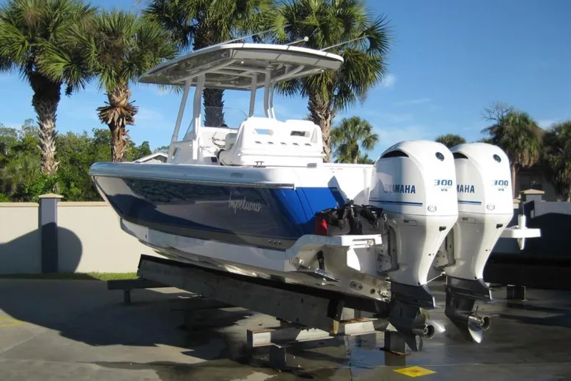 Slide: The Image of 2020 Intrepid 327 Center Console boat with twin Yamaha engines, parked outdoors. - 3