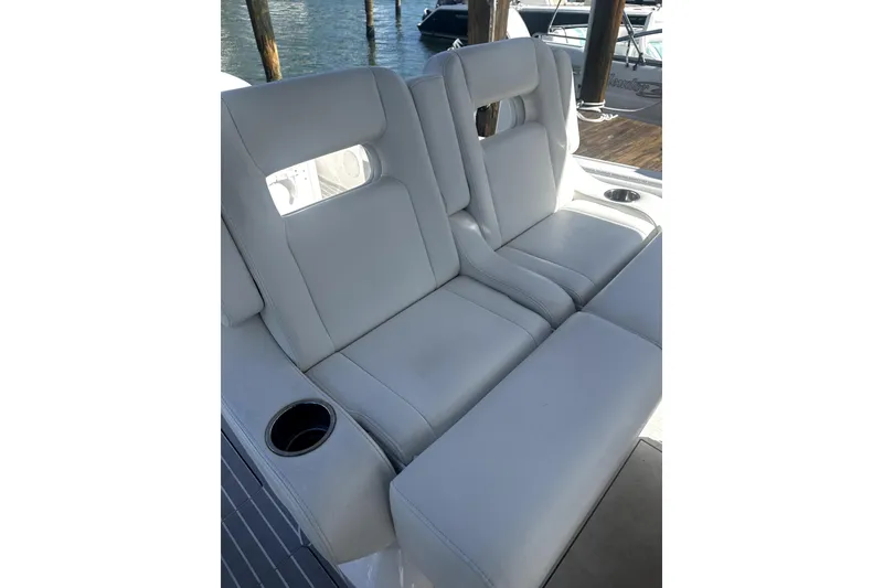 Slide: The Image of Luxurious seating on a 2020 Intrepid 327 Center Console boat, featuring cup holders. - 5
