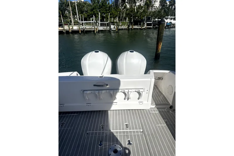 Slide: The Image of 2020 Intrepid 327 Center Console boat with dual engines docked by the water. - 6