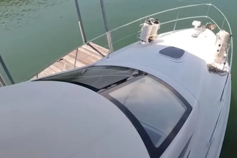 Slide: The Image of 2007 Sea Ray 36 Sedan Bridge yacht docked on calm water. - 14