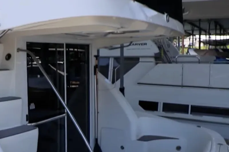 Slide: The Image of 2007 Sea Ray 36 Sedan Bridge yacht docked, showcasing sleek design and spacious deck area. - 6