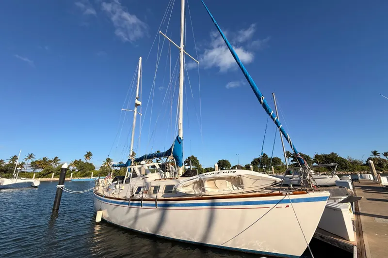 The Image of 1978 Morgan 452 sailboat docked at marina under clear blue sky. - 0