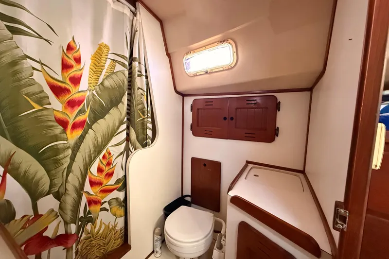 Slide: The Image of Bathroom in 1978 Morgan 452 yacht with tropical shower curtain and wooden cabinets. - 10