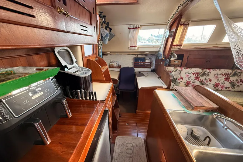 Slide: The Image of Interior of a 1978 Morgan 452 sailboat with kitchen and seating area. - 11