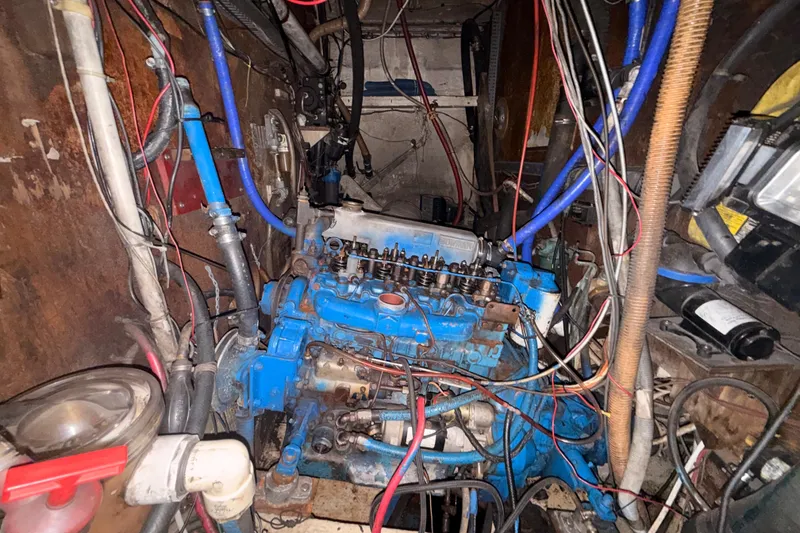 Slide: The Image of Engine compartment of a 1978 Morgan 452 sailboat with visible wiring and components. - 12