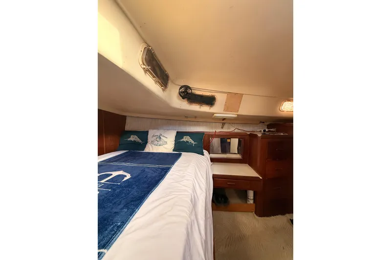 Slide: The Image of Cozy cabin interior of a 1978 Morgan 452 sailboat with bed and wooden furnishings. - 13