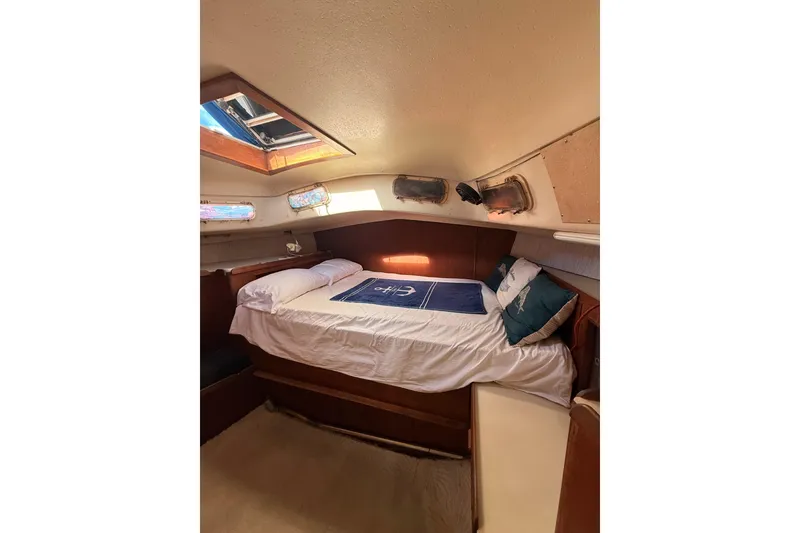 Slide: The Image of Cozy cabin interior of a 1978 Morgan 452 sailboat with a skylight and comfortable bedding. - 14