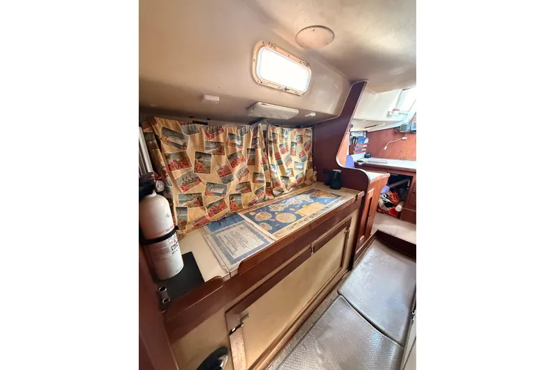 Slide: The Image of 1978 Morgan 452 yacht interior with colorful curtains and wooden cabinetry. - 16