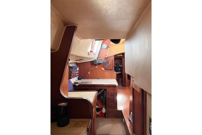 Slide: The Image of Interior of a 1978 Morgan 452 sailboat, featuring wooden cabinetry and nautical equipment. - 17