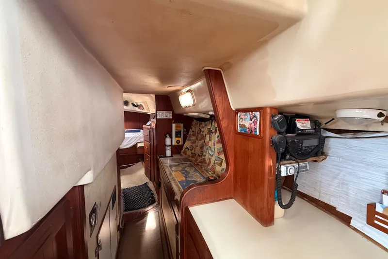 Slide: The Image of Interior of a 1978 Morgan 452 sailboat with cozy seating and navigation equipment. - 18