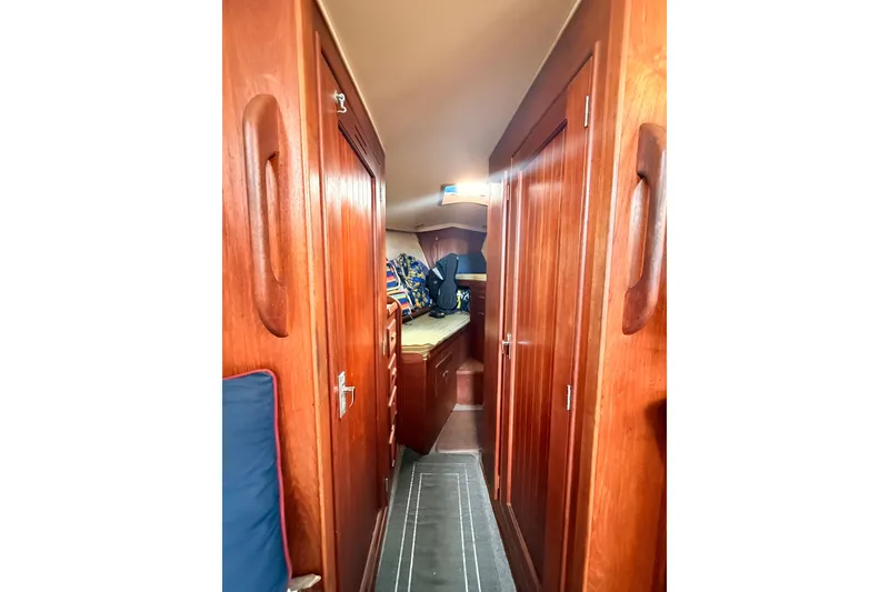 Slide: The Image of Interior of a 1978 Morgan 452 sailboat with wooden cabinetry and cozy sleeping area. - 20