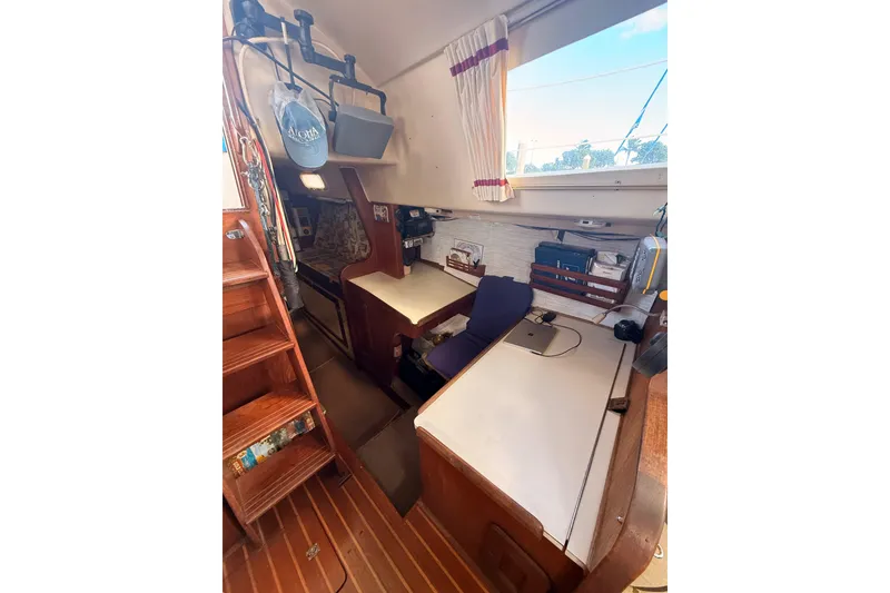 Slide: The Image of 1978 Morgan 452 yacht interior with wooden stairs, desk, and nautical decor. - 25