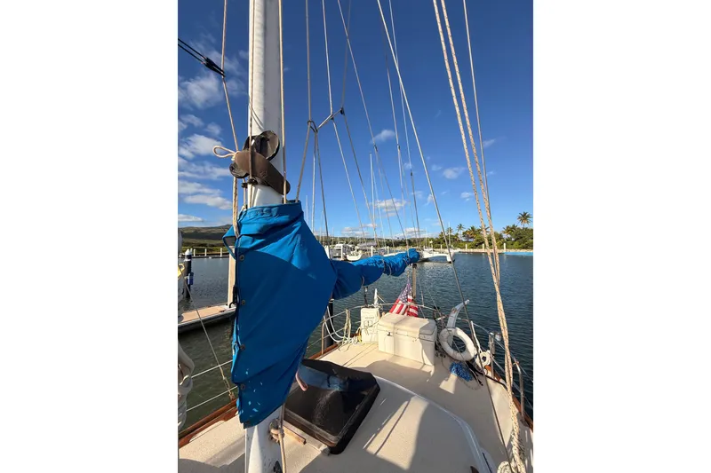 Slide: The Image of 1978 Morgan 452 sailboat docked in a sunny marina with clear blue skies. - 27
