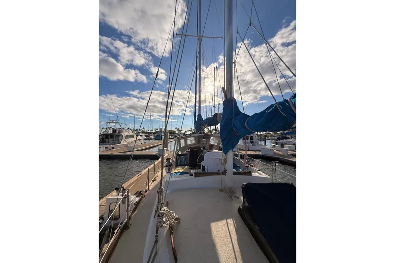 Slide: The Image of 1978 Morgan 452 sailboat docked at marina under a partly cloudy sky. - 28
