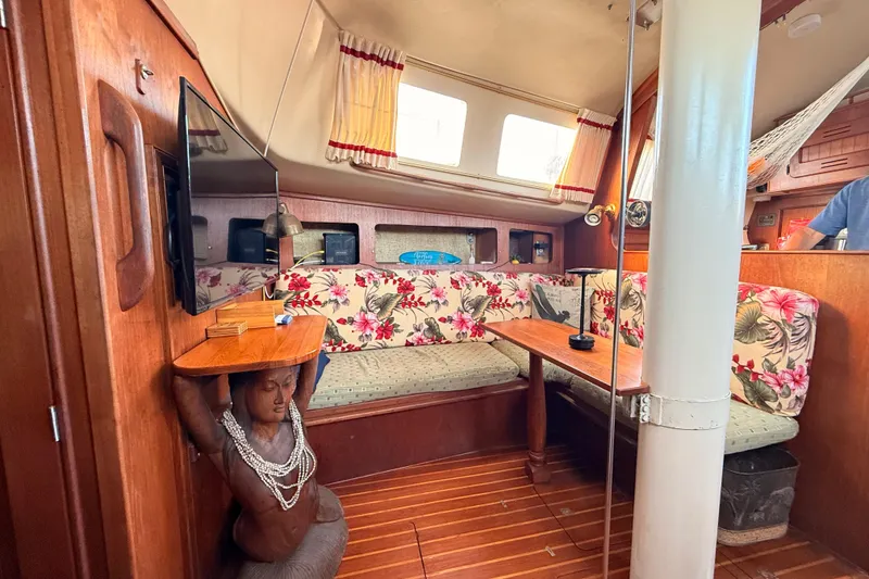 Slide: The Image of Interior of a 1978 Morgan 452 sailboat with floral seating and wooden decor. - 3