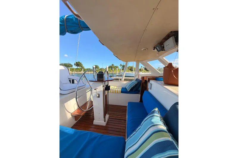Slide: The Image of 1978 Morgan 452 sailboat interior with blue cushions and wooden flooring. - 34