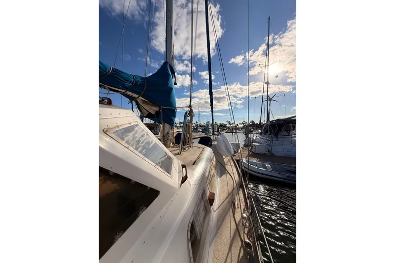 Slide: The Image of Sailboat docked at marina, Morgan 452, 1978 model, under a sunny sky. - 36