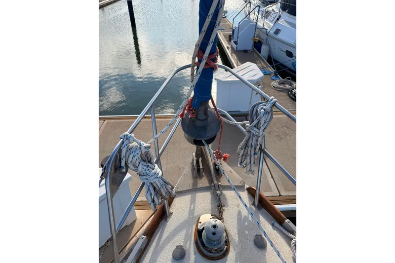 Slide: The Image of Bow of a 1978 Morgan 452 sailboat docked, featuring ropes and railing. - 37