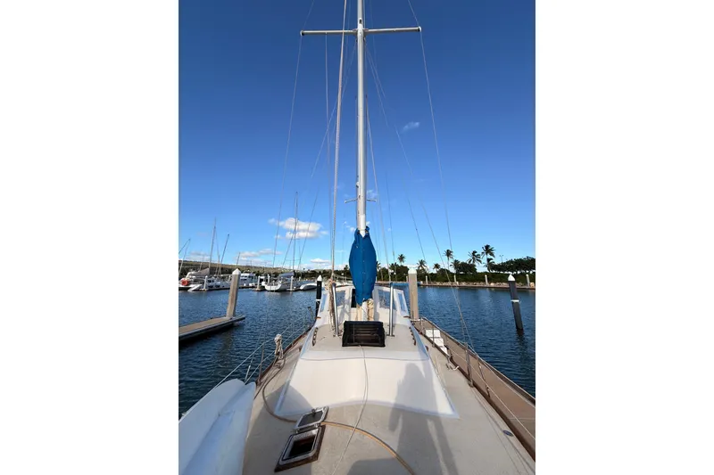 Slide: The Image of 1978 Morgan 452 sailboat docked in a marina under a clear blue sky. - 38